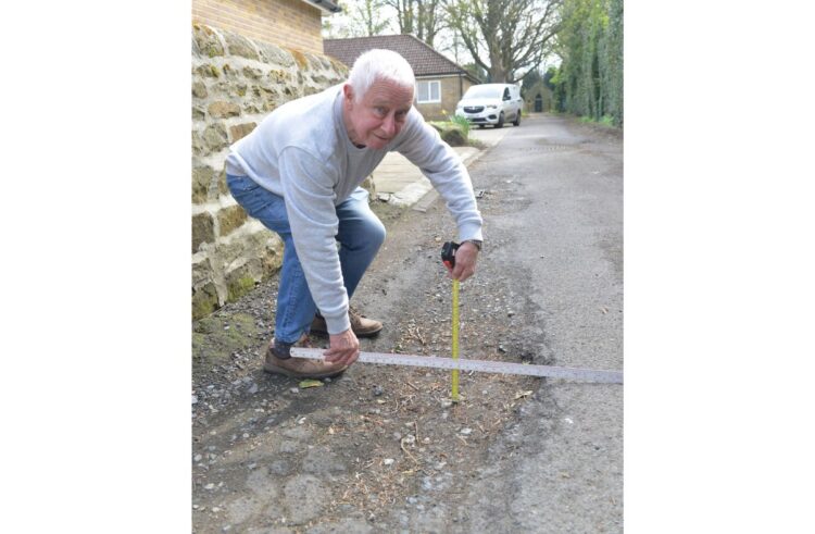 Repairs for road beset by potholes