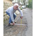 Repairs for road beset by potholes